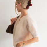 Woman with extra thick hair styling an updo using the VESITIA Maison Jumbo Claw Clipin Bordeaux.