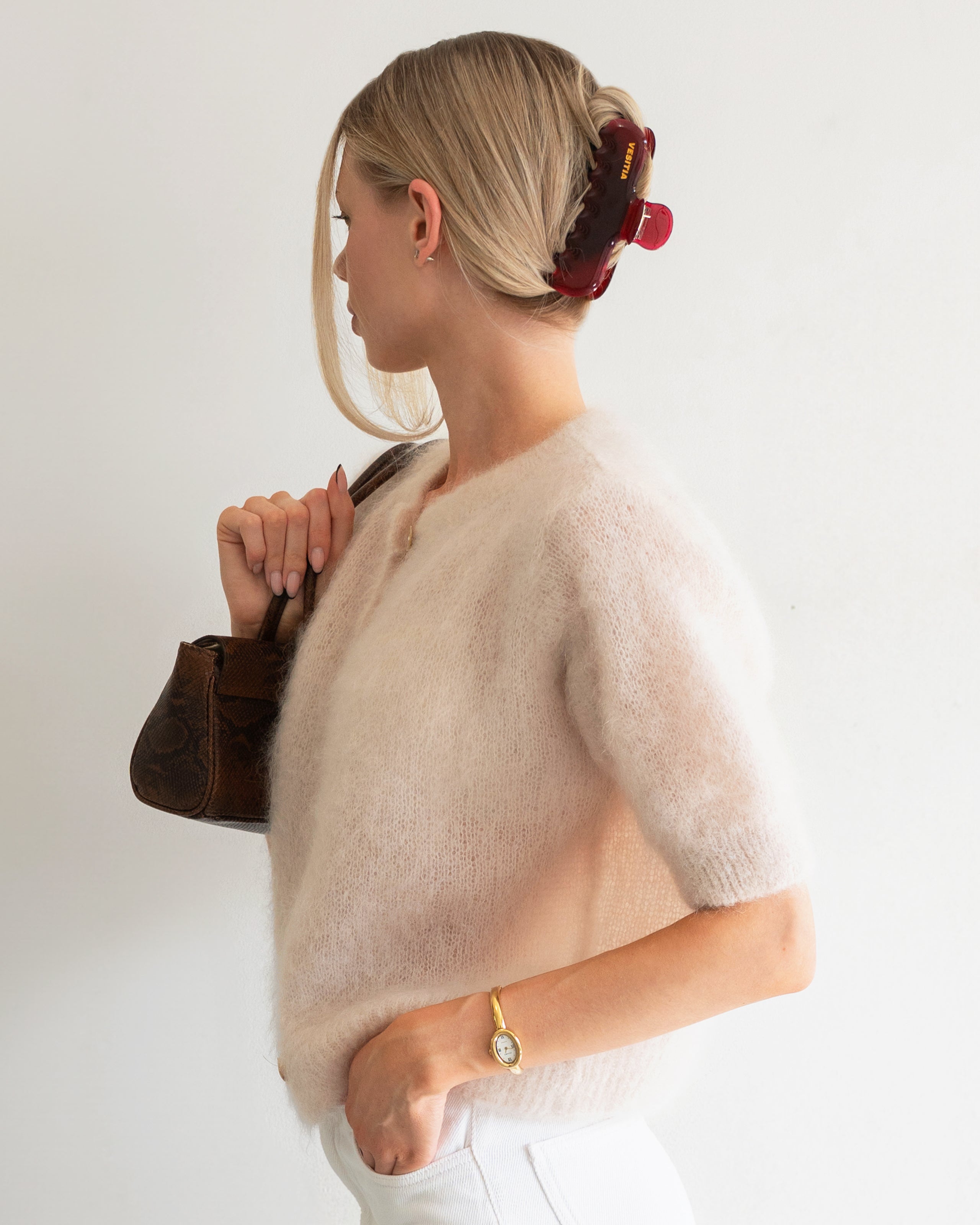 Woman with extra thick hair styling an updo using the VESITIA Maison Jumbo Claw Clipin Bordeaux.