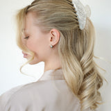 Woman with styled hair featuring a VESITIA bride claw clip on a white background