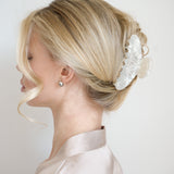 Woman with styled blonde hair featuring a VESITIA bride claw clip against a plain background