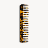 Tortoiseshell comb with 'VESITIA' branding on a white background