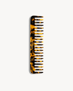 Tortoiseshell comb with 'VESITIA' branding on a white background