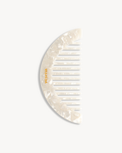 VESITIA comb with a shell-like pattern on a white background