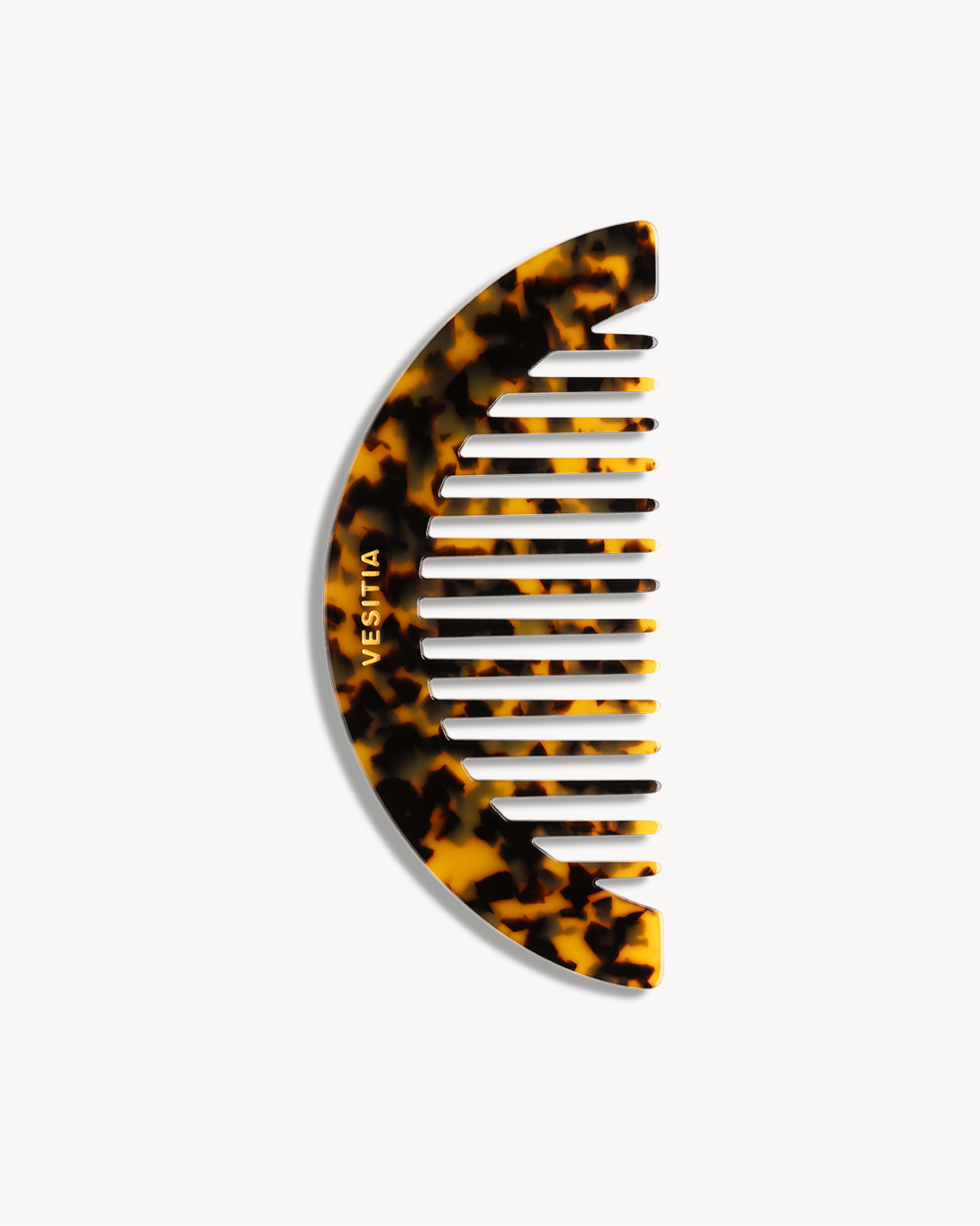 Tortoiseshell VESITIA hair comb with on a white background