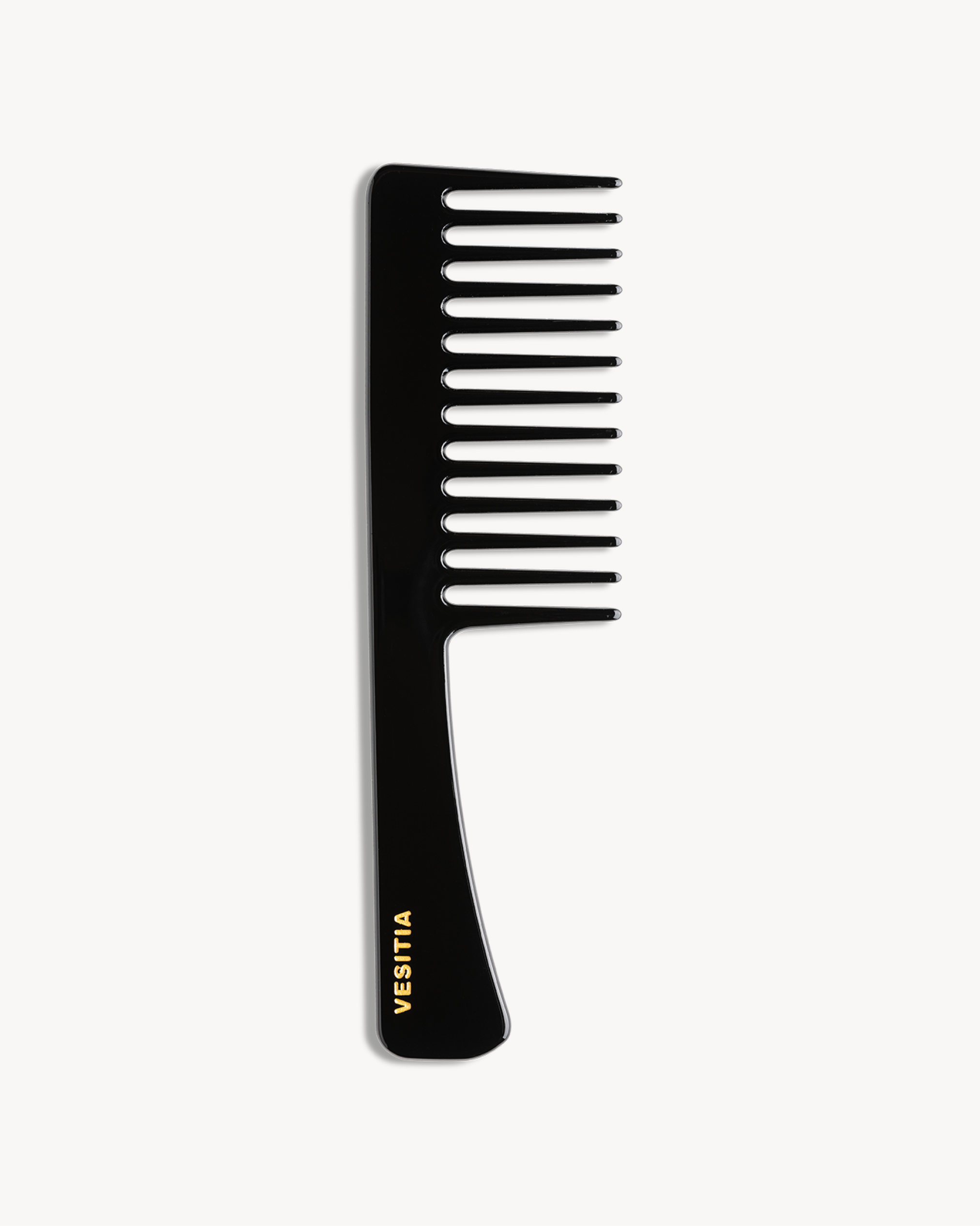 Black comb with 'VESITIA' branding on a white background