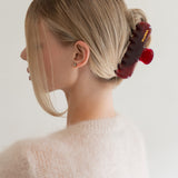 Woman with extra thick hair styling an updo using the VESITIA Maison Jumbo Claw Clip in Bordeaux.