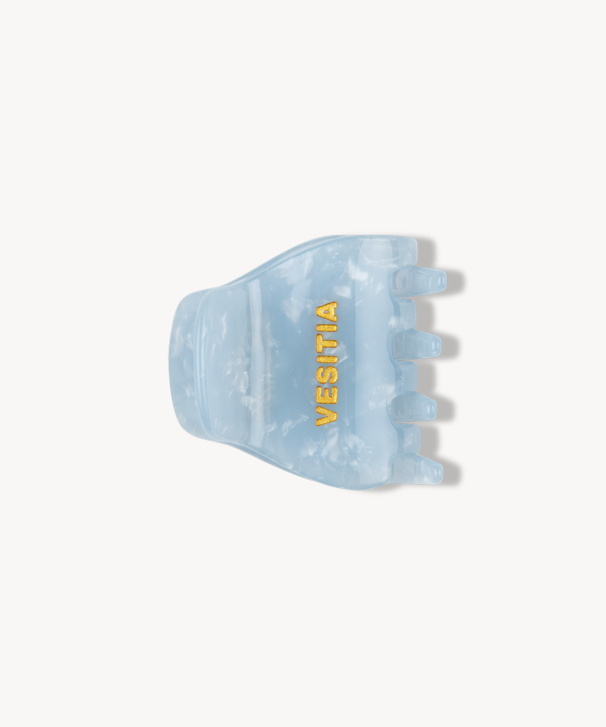 Blue hair clip with 'VESITIA' branding on a white background