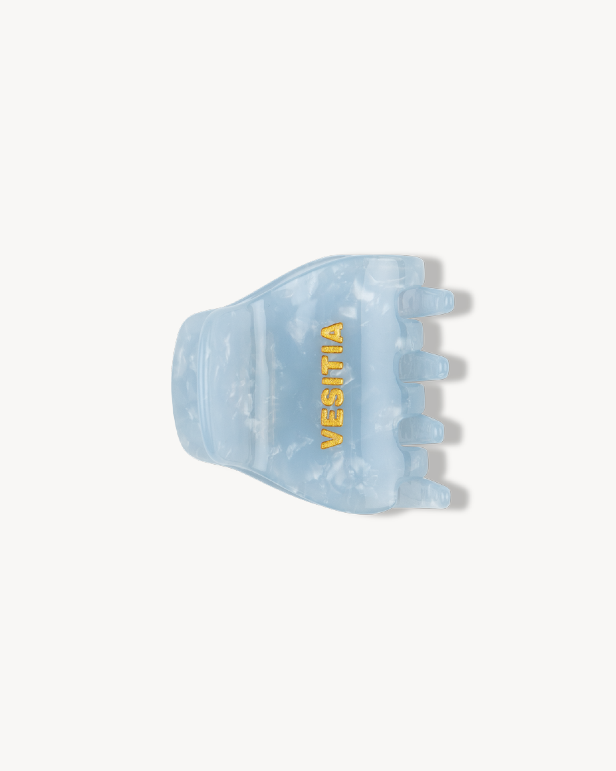 Blue hair clip with 'VESITIA' branding on a white background
