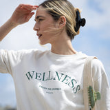 Woman wearing a white sweatshirt and a black VESITIA claw clip outdoors