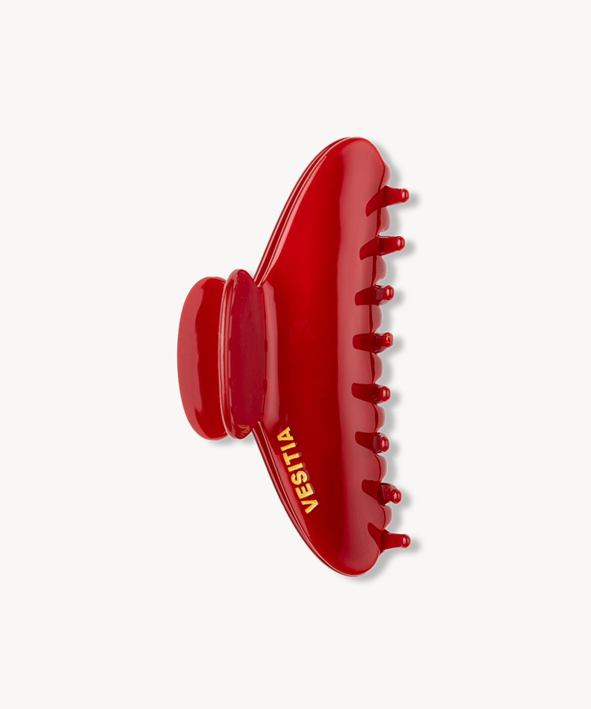 Red VESITIA claw clip on a white background