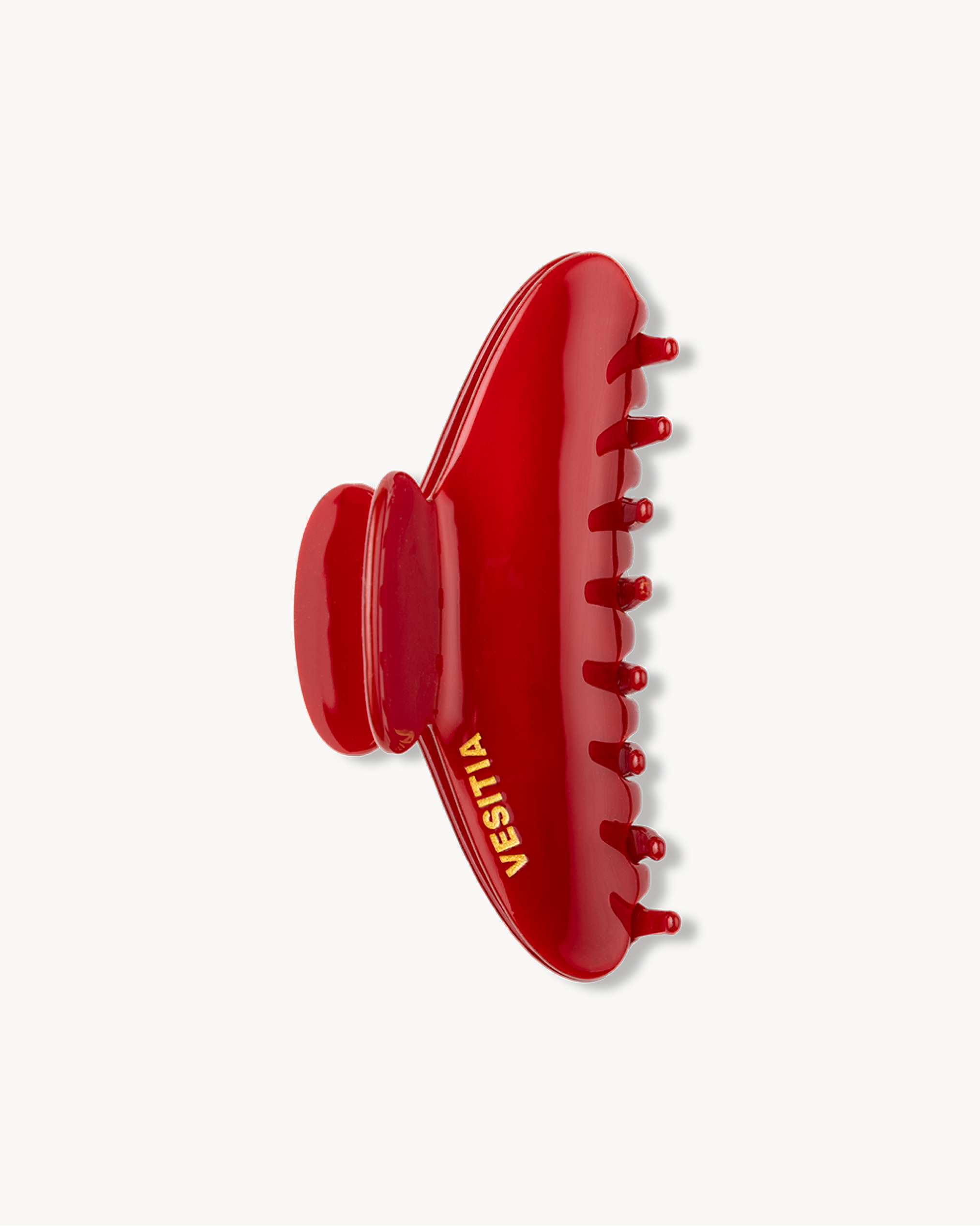 Red VESITIA claw clip on a white background