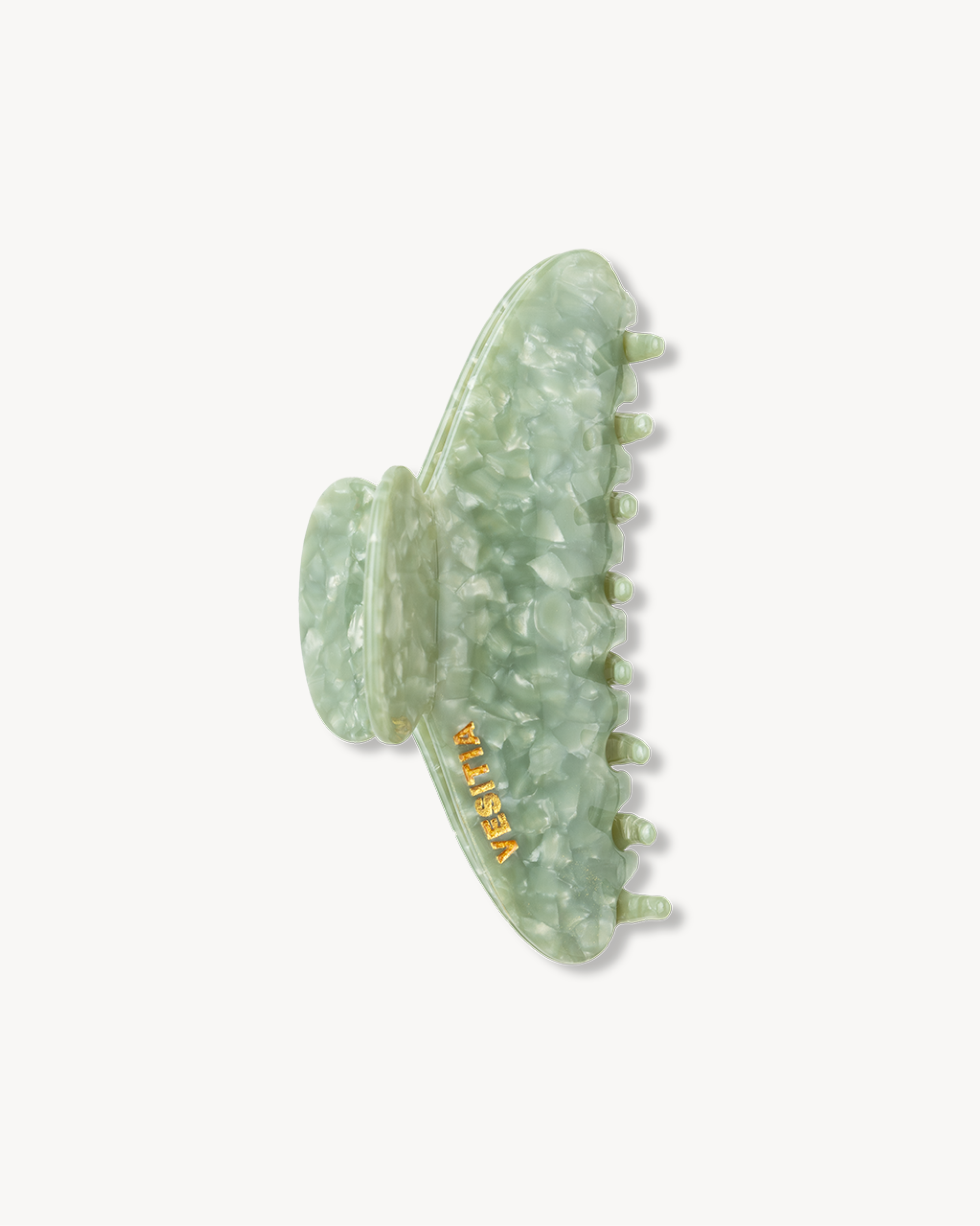 Green VESITIA signature claw clip on a white background